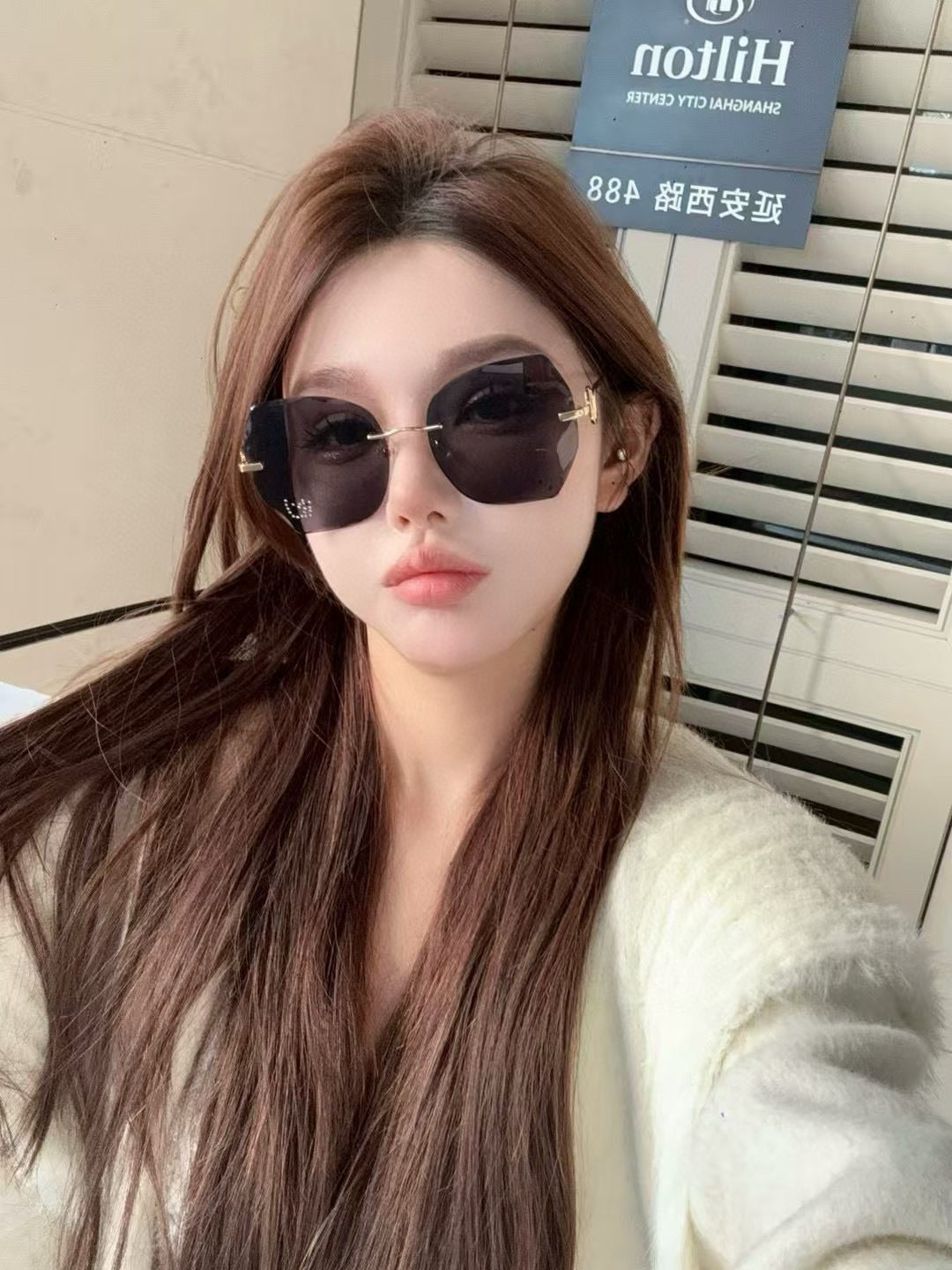 Unable to identify - images show sunglasses worn by a person, not product photography of luxury accessories/bags/wallets/belts