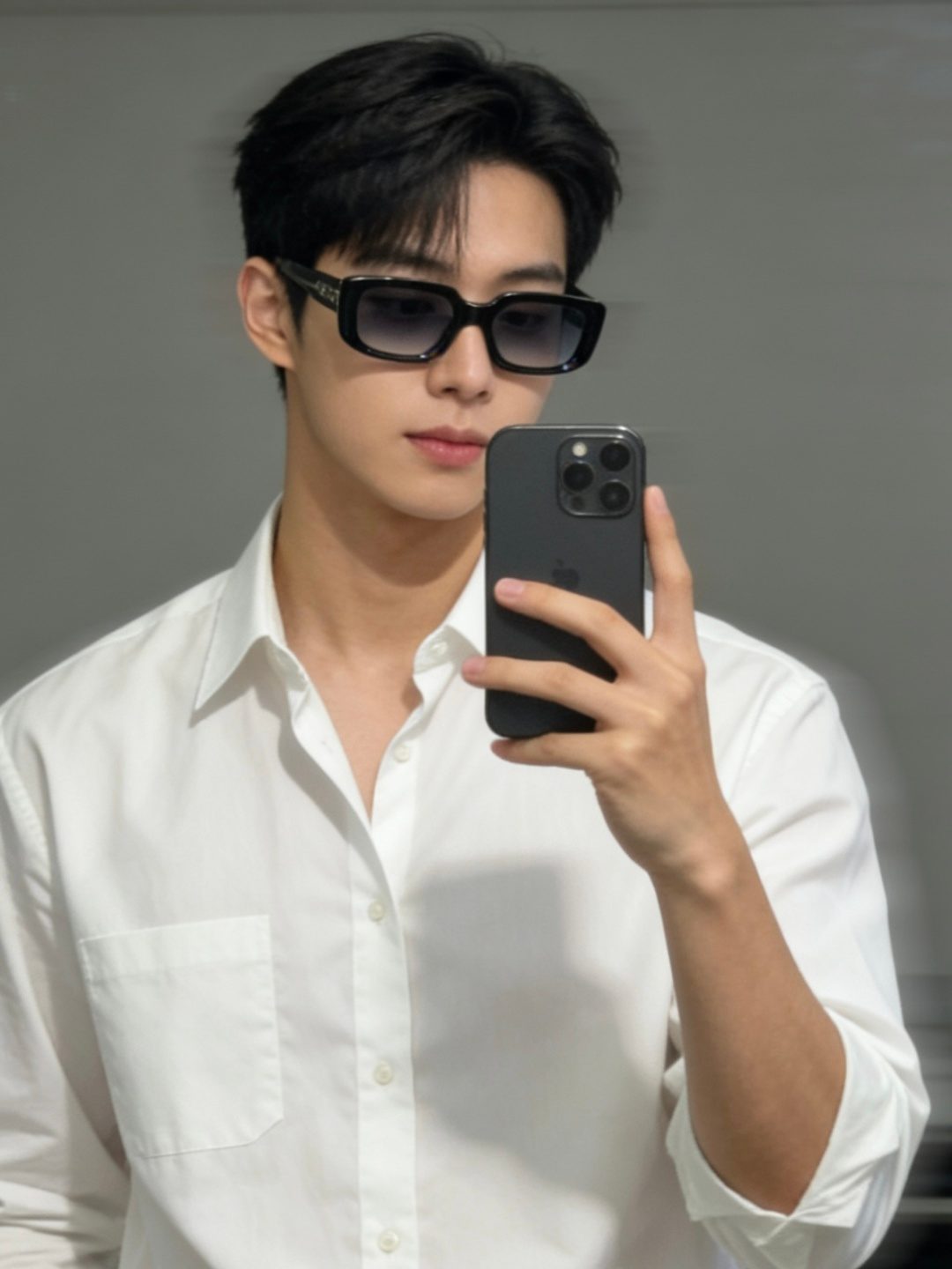 Unable to identify - these are portrait photos of a person wearing sunglasses and holding a phone, not product photos of accessories/bags/wallets/belts