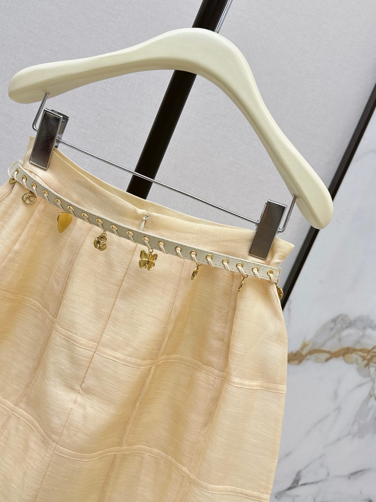 Cream Pleated Mini Skirt with Gold Charms